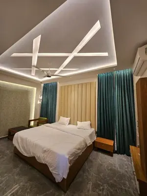 a bedroom with a bed with a ceiling fan at Kurunchi malar Resorts in Hosūr