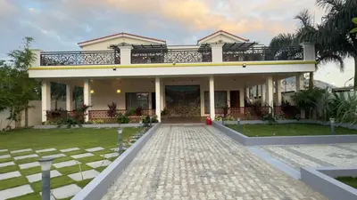a house with a balcony on top of it at Kurunchi malar Resorts in Hosūr