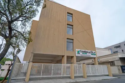 a building with a white fence in front of it at Treebo Premium Cachet Suites in Coimbatore