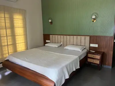 a bedroom with a bed and a green wall at Traditional house near Cochin airport in Chewarra