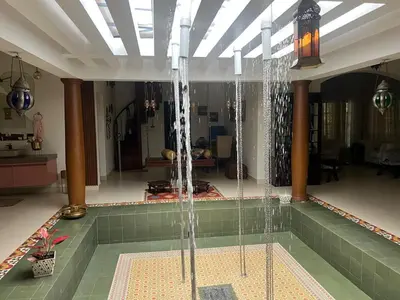 a swimming pool with water in a room at Traditional house near Cochin airport in Chewarra