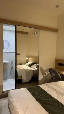 a hotel room with a bed and a mirror at The Zen Retreat in Kozhikode
