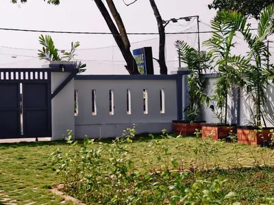 a house with a blue fence in a yard at Ambadis private pool villa in Pallipuram