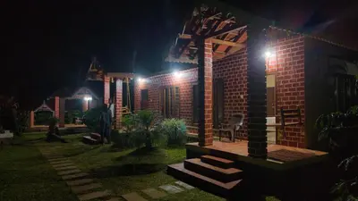 a building with lights on it at night at Coffee County in Srimangala