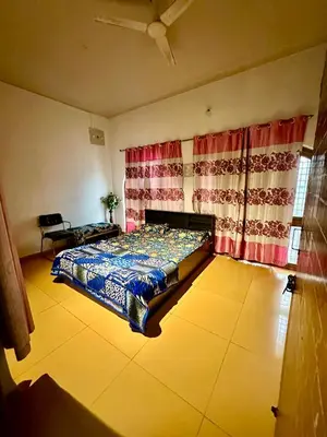 a bedroom with a bed in a room with curtains at Mysore City Center Rooms by A1k in Mysore