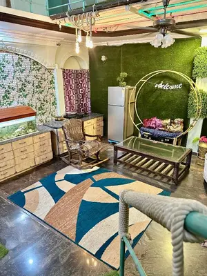a living room with a refrigerator and a rug at Mysore City Center Rooms by A1k in Mysore