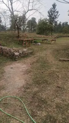 two picnic tables in a field with a green hose at Haven heights kanthalloor in Kanthalloor