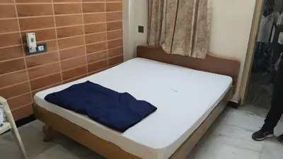 a small bed with a blue pillow on it at Tamar padinjarathara in Padinjarathara