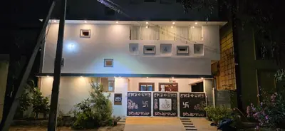 a white house at night with lights on it at SARA'S LUXURY stay in Coimbatore (Peelamedu)