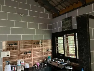 a bathroom with two sinks and a mirror and a window at Cozy Tiny Farm Stay in Mysore