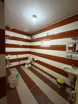a bathroom with a toilet and two sinks in a room at DM&sons guesthouse in Coonoor