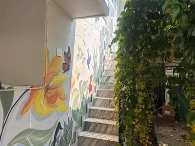 a stairway with a mural on the wall at Grace villa in Kunnamkulam