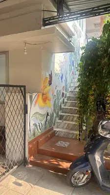 a mural on the side of a building with stairs at Grace villa in Kunnamkulam