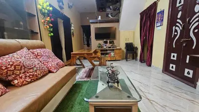 a living room with a couch and a glass table at BALS Villa in Tudiyalūr