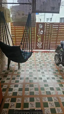 a hammock in a room with a tiled floor at BALS Villa in Tudiyalūr