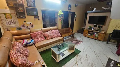 a living room with a couch and a television at BALS Villa in Tudiyalūr