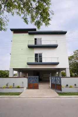 a large building with two gates in front of it at Ashley Homestay 2BHK Codissia, Airport, Tidel Park in Coimbatore