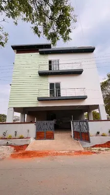 a large house with two gates in front of it at Ashley Homestay 2BHK Codissia, Airport, Tidel Park in Coimbatore