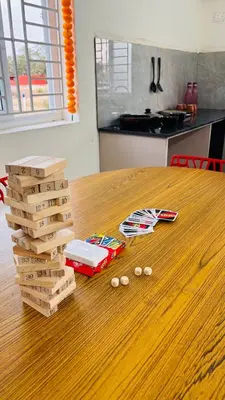 a table with a stack of pizza boxes on it at Ashley Homestay 2BHK Codissia, Airport, Tidel Park in Coimbatore