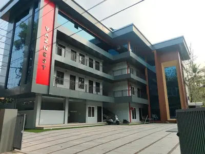 a building with a red sign on it at vaznest in Nilambūr