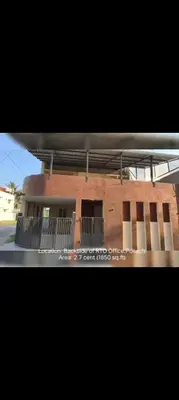 a brick building with a balcony on the side of it at R N P Guest House in Pollāchi