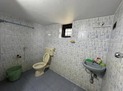 a bathroom with a toilet and a sink at Sreekrishnapuram Family Retreat in Karimpuzha