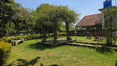 a garden with a tree in the middle of a yard at Nakshatra individual villa in Ooty