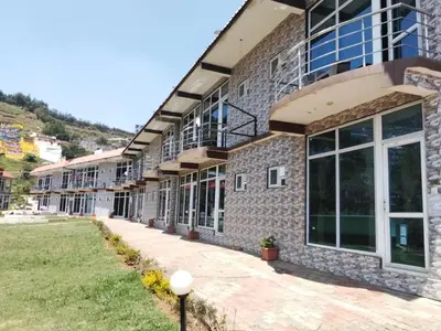 a building with a walkway in front of it at TULIPS VILLAGE RESORTS - A Valley View Abode in Ooty