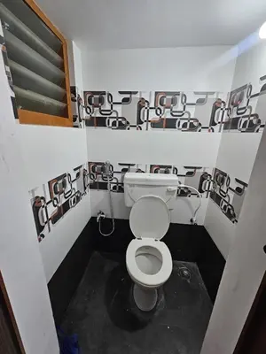 a small bathroom with a toilet in a room at Home in Pollachi in Pollāchi