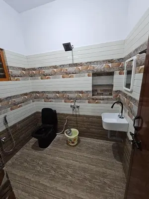 a bathroom with a toilet and a sink at Home in Pollachi in Pollāchi