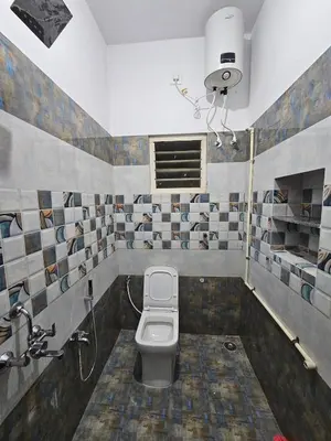 a bathroom with a toilet and a sink at Home in Pollachi in Pollāchi