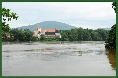 a house sitting on the bank of a river at SHANKARAM Homestay in Kodanad