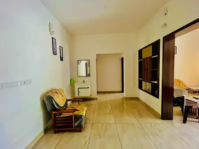 a living room with a couch and a table at Nilavu Homes Retreat in Wayanad