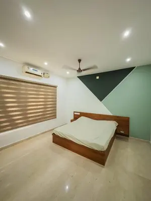 a bedroom with a bed and a ceiling at Akshaya Homestay in Trichūr