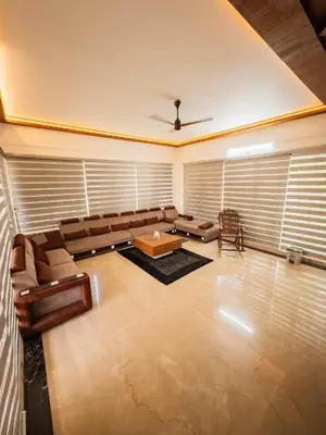 a large living room with a couch and a table at Akshaya Homestay in Trichūr