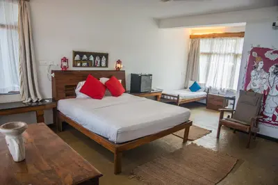 a bedroom with a bed with red pillows on it at 36 Palms Boutique Retreat in Cherai Beach