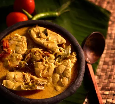 a bowl of food sitting on top of a table at 36 Palms Boutique Retreat in Cherai Beach