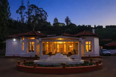 a house with a fountain in front of it at Mount View Heritage by Z Vacations in Ooty