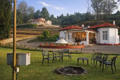 a group of chairs in front of a house at Mount View Heritage by Z Vacations in Ooty