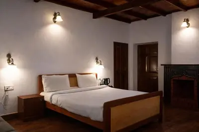 a bedroom with a bed and two lights on the wall at Mount View Heritage by Z Vacations in Ooty