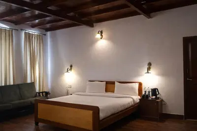 a bedroom with a bed and a couch and lights at Mount View Heritage by Z Vacations in Ooty