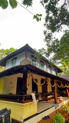 a yellow house with orange garbons in front of it at Kakkakuni heritage in Kozhikode