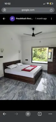 a bedroom with a large bed in a room at Poozhikuth Homestay in Sultan Bathery