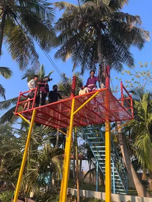 a group of people riding on a roller coaster at Bombe Resort Channapatna in Channapatna