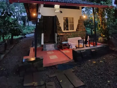 a house with a red floor and a porch at Echupary Estate cottage in Gonikoppal