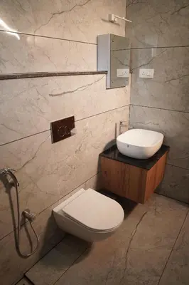 a bathroom with a toilet and a sink at Kashmeeram Resort in Vayittiri