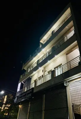 a building with balconies on the side of it at night at Forum Stay in Mysore