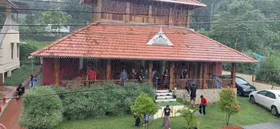 a group of people standing in front of a building at JackRoot Athirappilly in Kallana