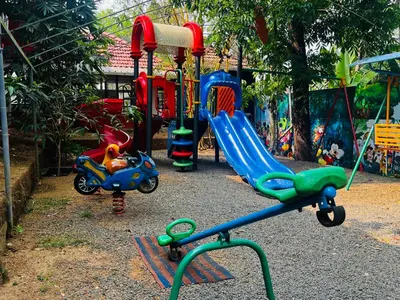 a playground with several different types of play equipment at Flavoury Restaurant & Rooms in Paithalmala