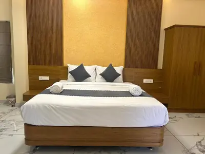 a bedroom with a large bed in a room at FORTUNE BANASURA Resort in Kalpetta